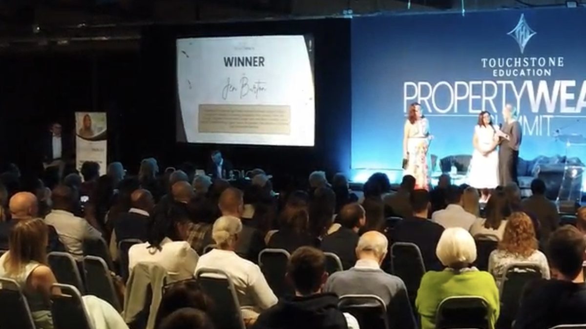 Jen on stage at the Property Wealth Summit as the Best Holiday Let winner is announced